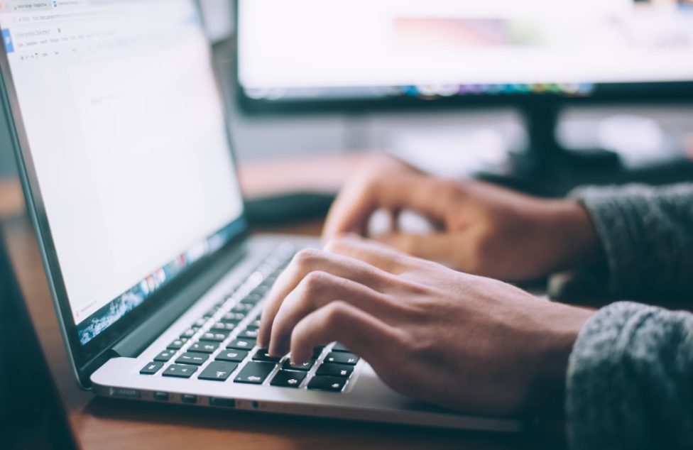 hands on the keyboard of a laptop